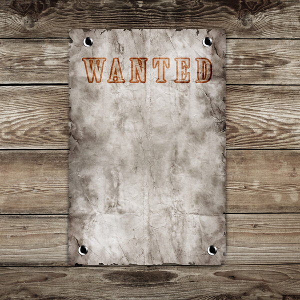 Old western wanted poster on wooden background