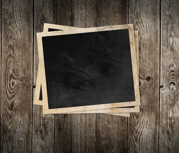 Blank photo frame on wooden background — Stock Photo, Image