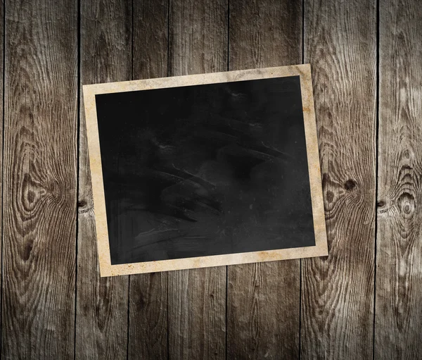 Blank photo frame on wooden background — Stock Photo, Image