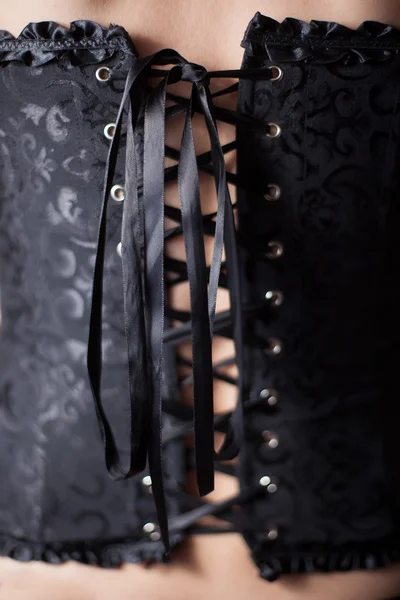 Close-up shot of woman in black corset — Stock Photo, Image