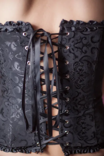 Close-up shot of woman in black corset — Stock Photo, Image