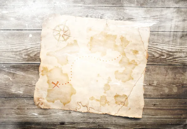 Old treasure map on wooden background — Stock Photo, Image