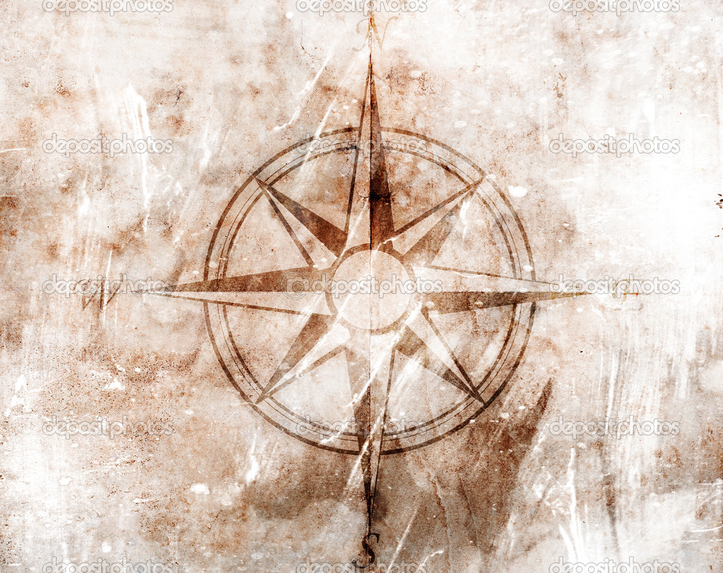 Old compass on paper background