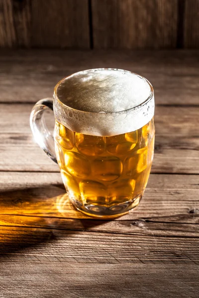 Кружка пива на деревянном фоне — стоковое фото
