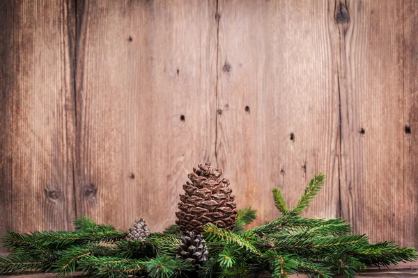Ramas de árbol de Navidad con protuberancias sobre fondo de madera —  Fotos de Stock