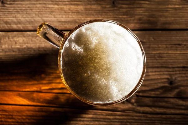 Mug of beer on wooden background — Stock Photo, Image