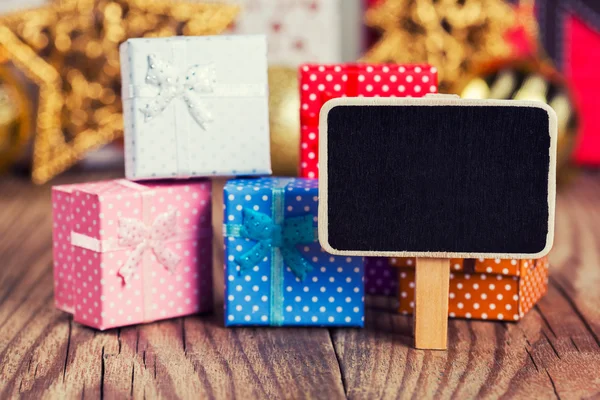 Kleine schoolbord tegen geschenkdozen — Stockfoto