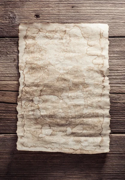 Old paper on wood background — Stock Photo, Image