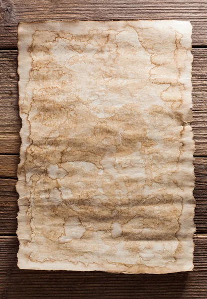 Old paper on wood background — Stock Photo, Image