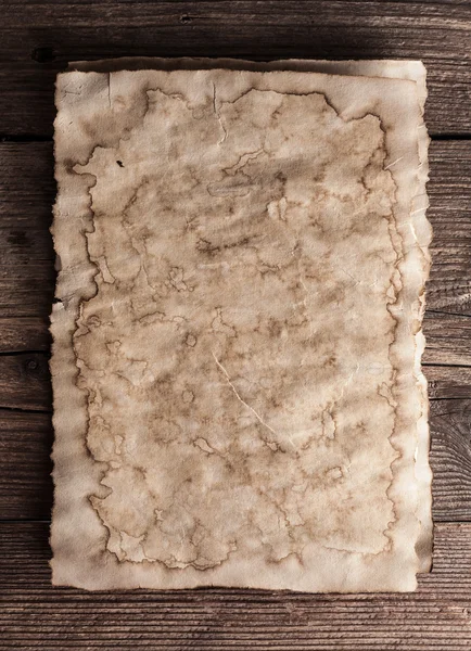 Old paper on wood background — Stock Photo, Image