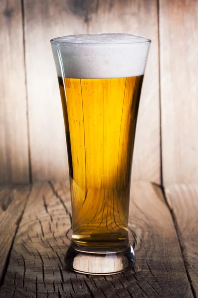 Mug of beer on wooden background — Stock Photo, Image