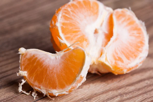 A mandarin on wooden background — Stock Photo, Image