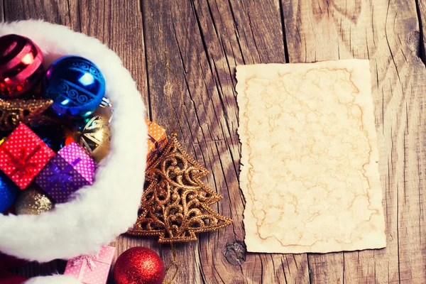 Vintage paper with Santa's hat — Stock Photo, Image