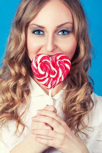 Beautiful young woman with lollipop — Stock Photo, Image