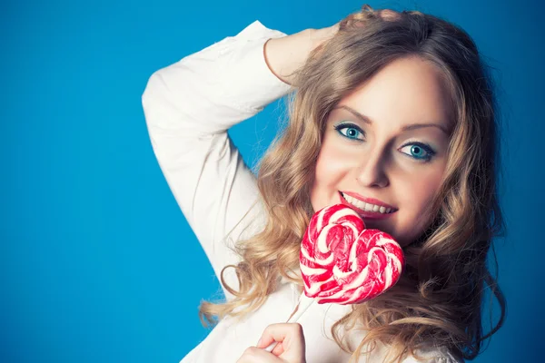 Beautiful young woman with lollipop — Stock Photo, Image