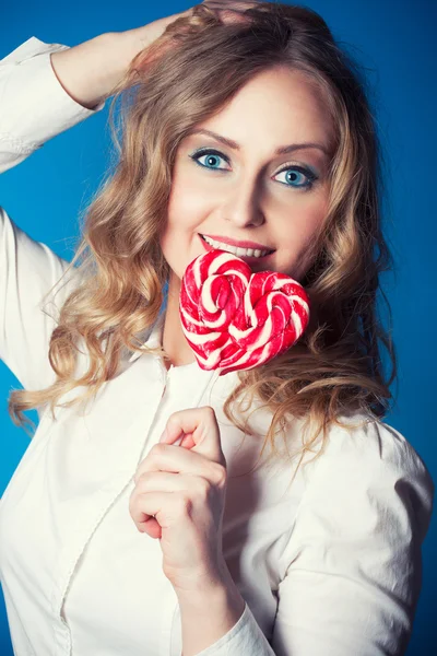 Beautiful young woman with lollipop — Stock Photo, Image