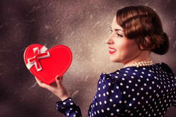 Woman with heart-shaped gift — Stock Photo, Image