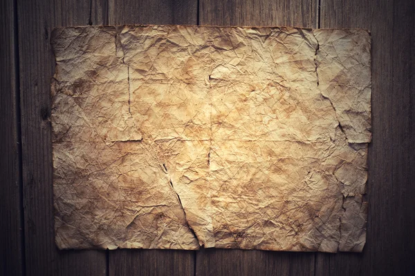 Old paper on wood background — Stock Photo, Image