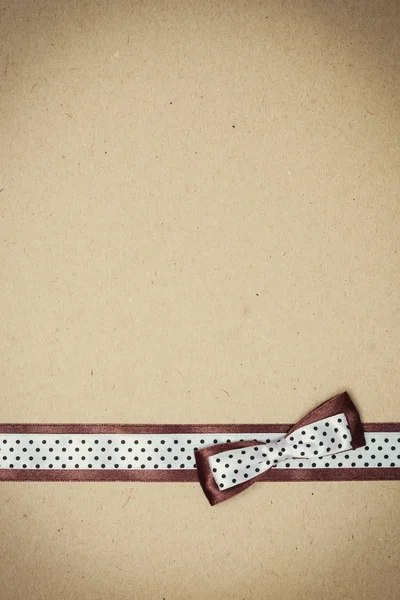 Polka dot ribbon on old paper — Stock Photo, Image