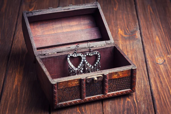 Earrings on chest — Stock Photo, Image