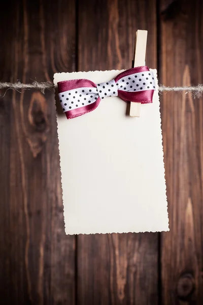 Paper sheet with bow — Stock Photo, Image