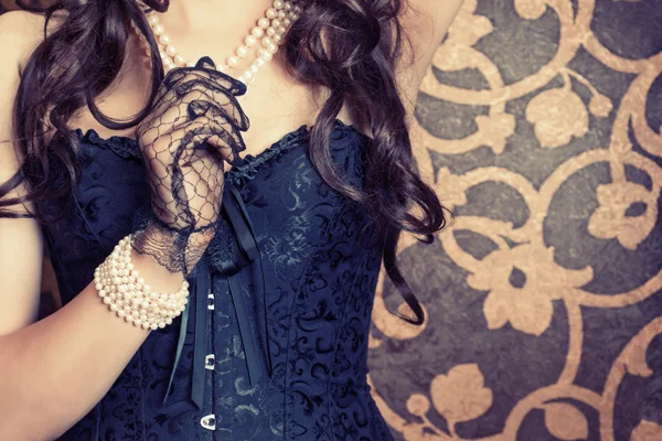 Woman wearing black corset and pearls — Stock Photo, Image