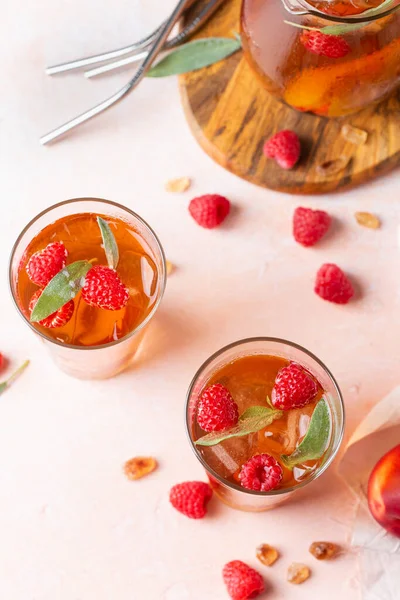 Peach raspberry iced tea with sage. Summer refreshing drink, beverage, cocktail