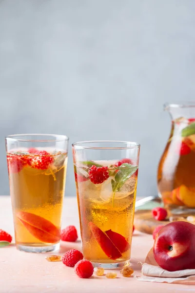 Peach raspberry iced tea with sage. Summer refreshing drink, beverage, cocktail