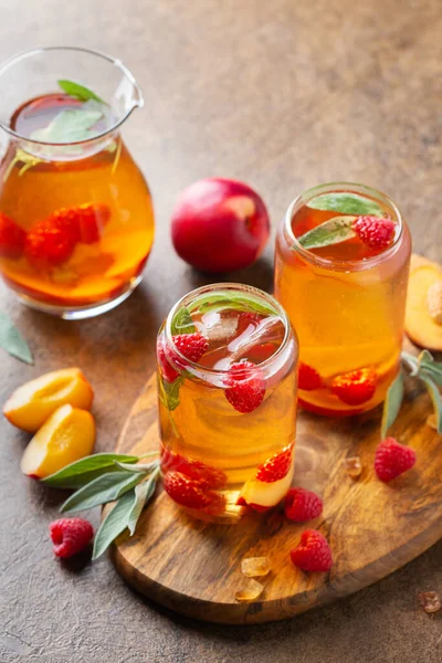 Peach raspberry iced tea with sage. Summer refreshing drink, beverage, cocktail