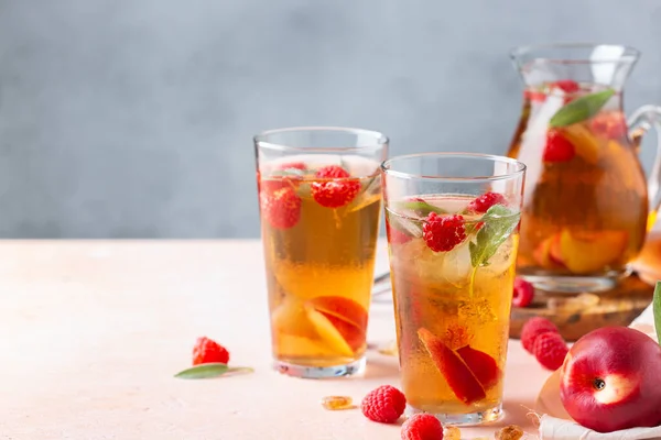 Peach raspberry iced tea with sage. Summer refreshing drink, beverage, cocktail