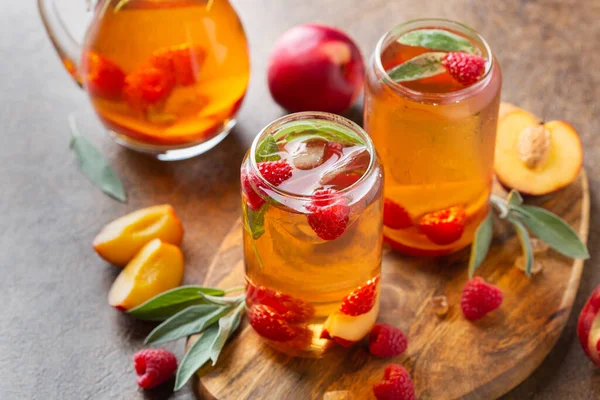 Peach raspberry iced tea with sage. Summer refreshing drink, beverage, cocktail