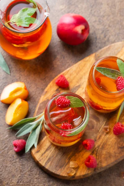 Peach raspberry iced tea with sage. Summer refreshing drink, beverage, cocktail