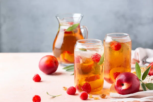 Peach raspberry iced tea with sage. Summer refreshing drink, beverage, cocktail