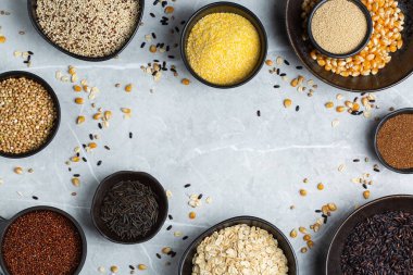 Healthy eating, dieting, balanced food concept. Assortment of gluten free cereals, corn, rice, amaranth, teff, buckwheat, quinoa and oat on a table. Top view flat lay background