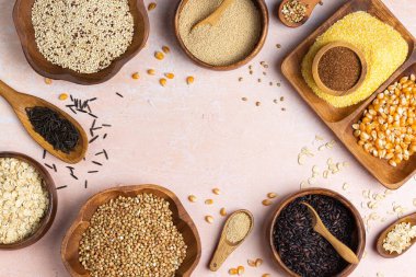 Healthy eating, dieting, balanced food concept. Assortment of gluten free cereals, corn, rice, amaranth, teff, buckwheat, quinoa and oat on a table. Top view flat lay background