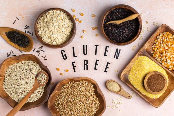 Healthy eating, dieting, balanced food concept. Assortment of gluten free cereals, corn, rice, amaranth, teff, buckwheat, quinoa and oat on a table. Top view flat lay background