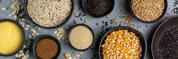 Healthy eating, dieting, balanced food concept. Assortment of gluten free cereals, corn, rice, amaranth, teff, buckwheat, quinoa and oat on a table. Top view flat lay background, banner