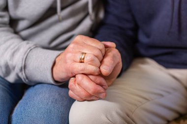 Senior married couple holding hands together. Family, help, elderly care and support concept