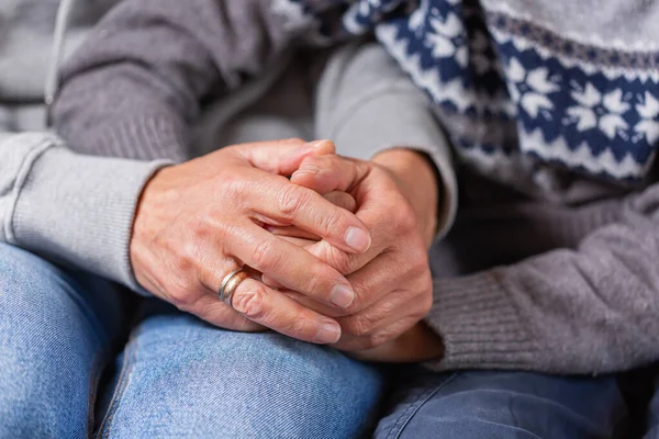 Senior woman and a child holding hands together. Family, help, elderly care and support concept