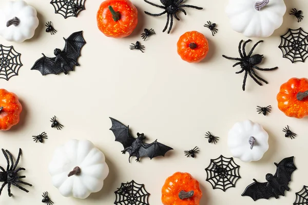 Happy Halloween, trick or treat greeting card with bats, spiderweb, spider, skull and pumpkins. Flat lay composition, copy space mockup template