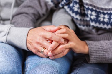 Senior woman and a child holding hands together. Family, help, elderly care and support concept