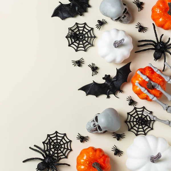 Happy Halloween, trick or treat greeting card with bats, spiderweb, spider, skull and pumpkins. Flat lay composition, copy space mockup template