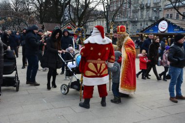 Lviv, Ukrayna - Aralık 2021: Lviv Noel Fuarı 2021. Yeni yıl ve Noel kutlamaları sırasında Nicholas ve Noel Baba.