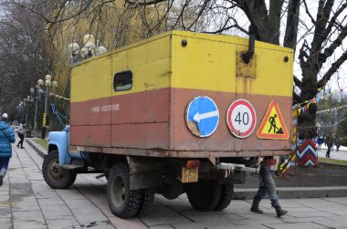 Rivne. Ukraine. November, 2021.municipal blue red yellow color ussr old electric service and water supply repair GAZ 53, vintage classic car arriving on emergency call drive on city urban street