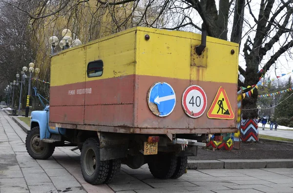 Rivne. Ukraine. November, 2021.municipal blue red yellow color ussr old electric service and water supply repair GAZ 53, vintage classic car arriving on emergency call drive on city urban street