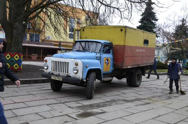 Rivne. Ukraine. November, 2021.municipal blue red yellow color ussr old electric service and water supply repair GAZ 53, vintage classic car arriving on emergency call drive on city urban street
