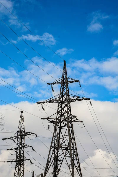 Power Transmission Line .High voltage power lines pylons and electrical cables on a clear blue sky background. Modern infrastructure of high voltage transmission lines. Energy industry.