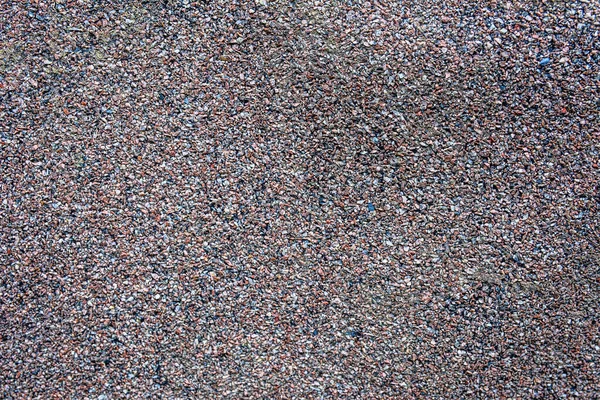 ruberoid texture of roofing material bituminous coating with stone chips to protect the roof of the house from moisture and rain, roofing material surface closeup.