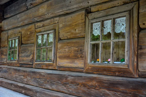 Very old grunged wooden window frame.Windows with wooden architraves .The old window of old wooden house. Background of wooden walls