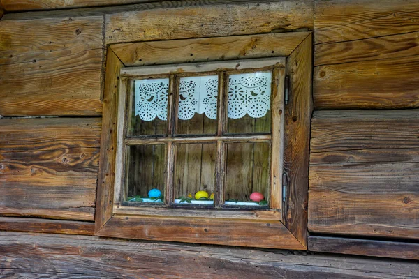 Very old grunged wooden window frame.Windows with wooden architraves .The old window of old wooden house. Background of wooden walls